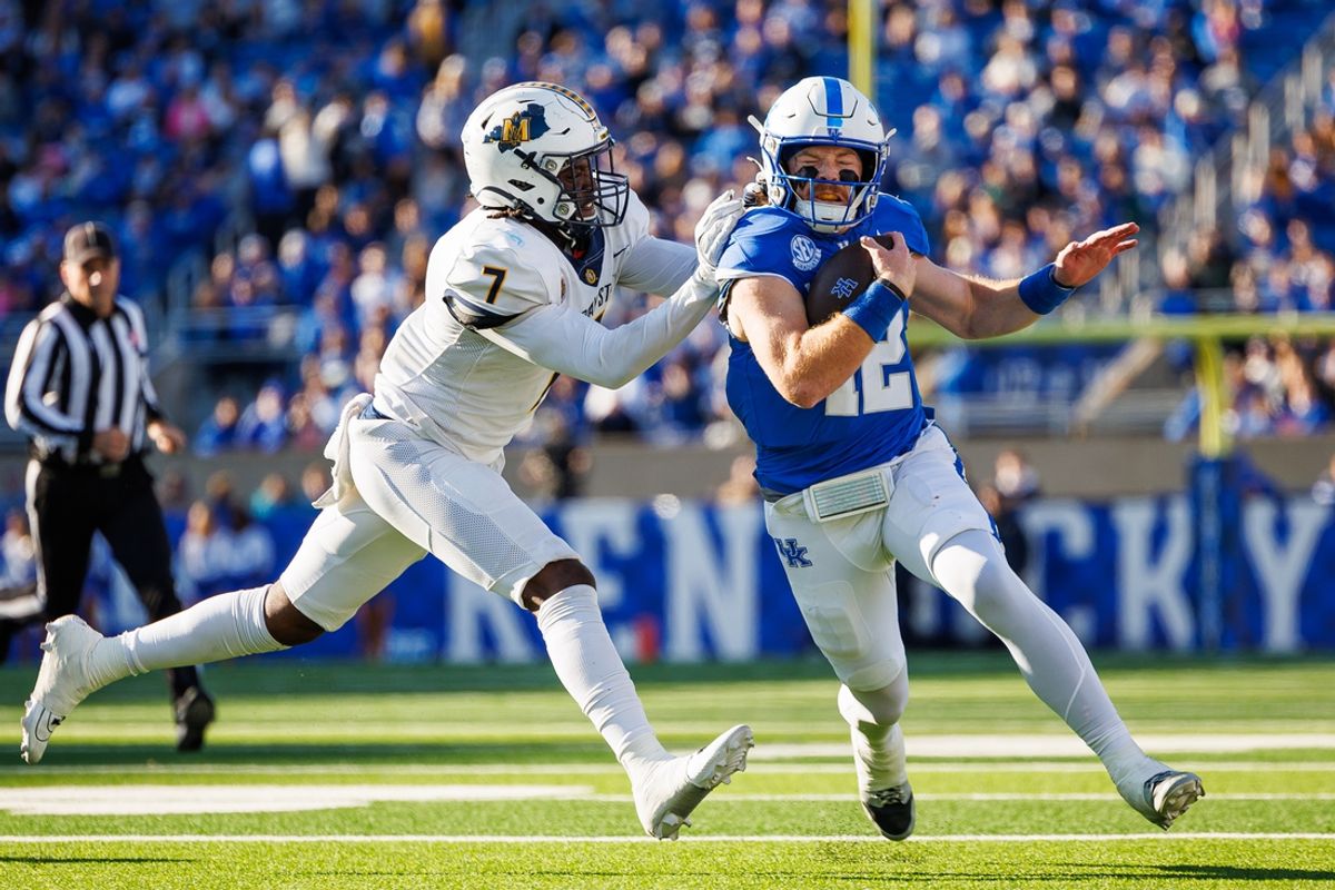 Nov 16, 2024; Lexington, Kentucky, USA; Kentucky Wildcats quarterback Brock Vandagriff (12) is forced out of bounds by Murray State Racers linebacker Justice Cross (7) during the second quarter at Kroger Field. Mandatory Credit: Jordan Prather-Imagn Images