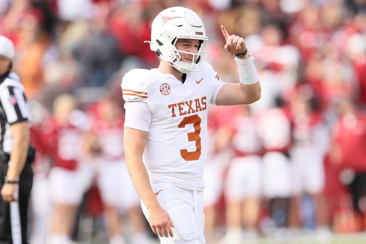 Nov 16, 2024; Fayetteville, Arkansas, USA; Texas Longhorns quarterback Quinn Ewers (3) celebrates after making a final first down to end the game against the Arkansas Razorbacks at Donald W. Reynolds Razorback Stadium. Texas won 20-10. Mandatory Credit: Nelson Chenault-Imagn Images