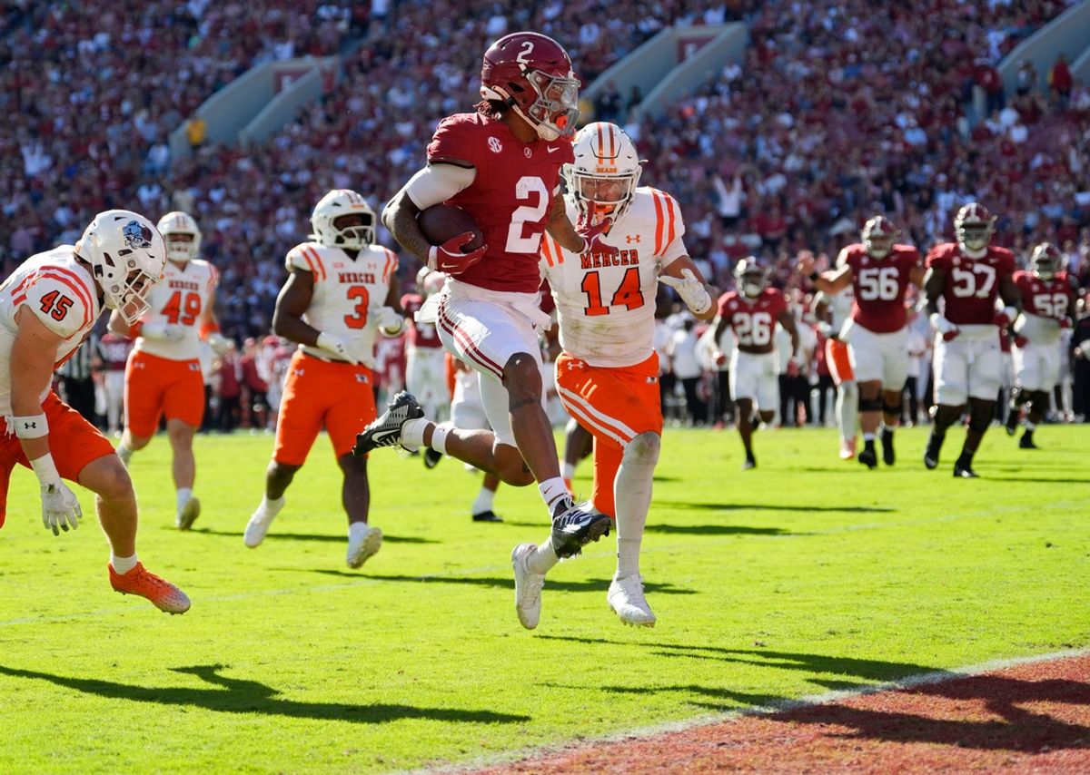 Nov 16, 2024; Tuscaloosa, AL, USA; Alabama Crimson Tide wide receiver Ryan Williams (2) leaps past Mercer safety Chris Joines (14) as he scores at Bryant-Denny Stadium. Mandatory Credit: Gary Cosby Jr.-Tuscaloosa News