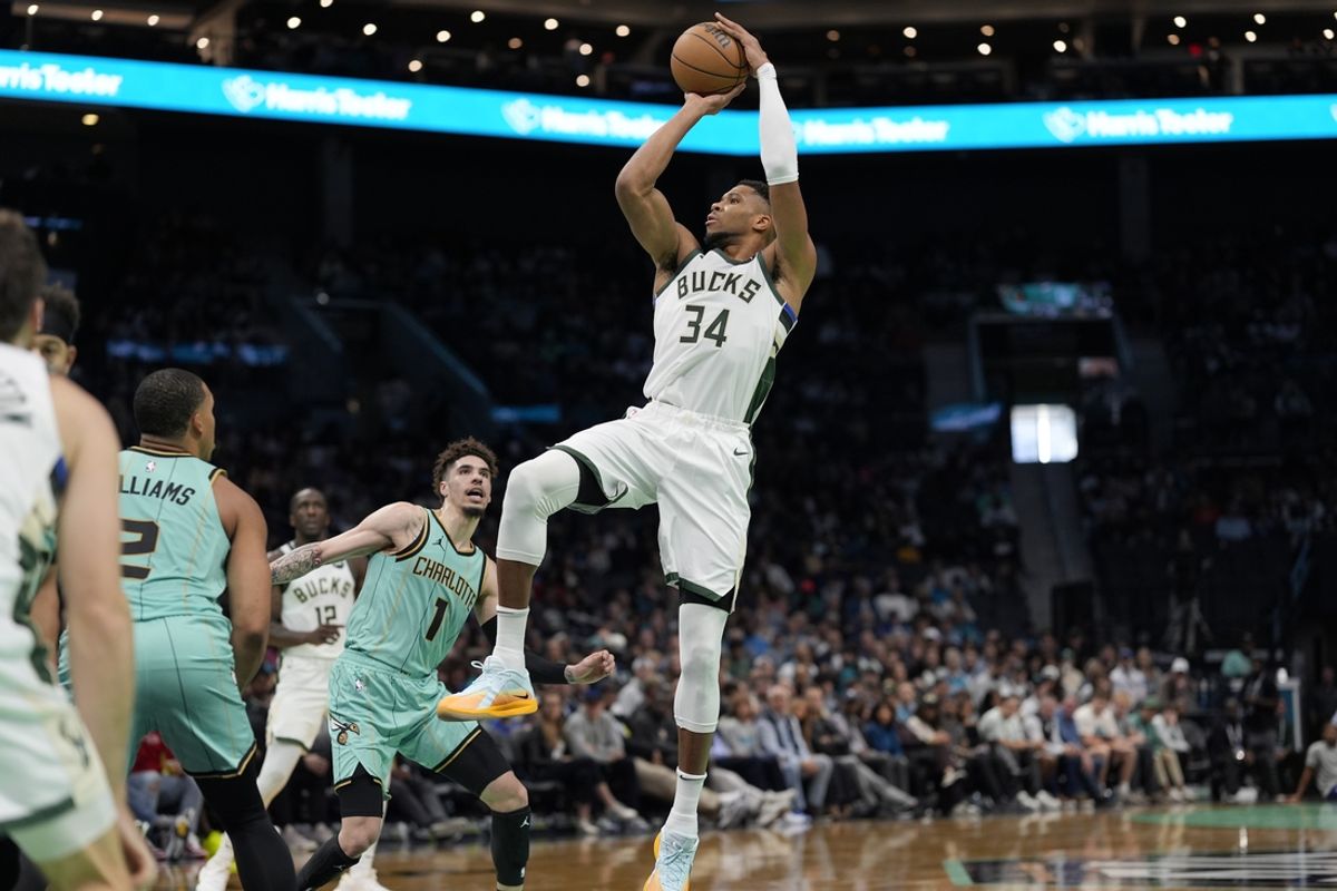 Nov 16, 2024; Charlotte, North Carolina, USA; Milwaukee Bucks forward Giannis Antetokounmpo (34) shoots a jumper against Charlotte Hornets guard LaMelo Ball (1) during the second quarter at Spectrum Center. Mandatory Credit: Jim Dedmon-Imagn Images