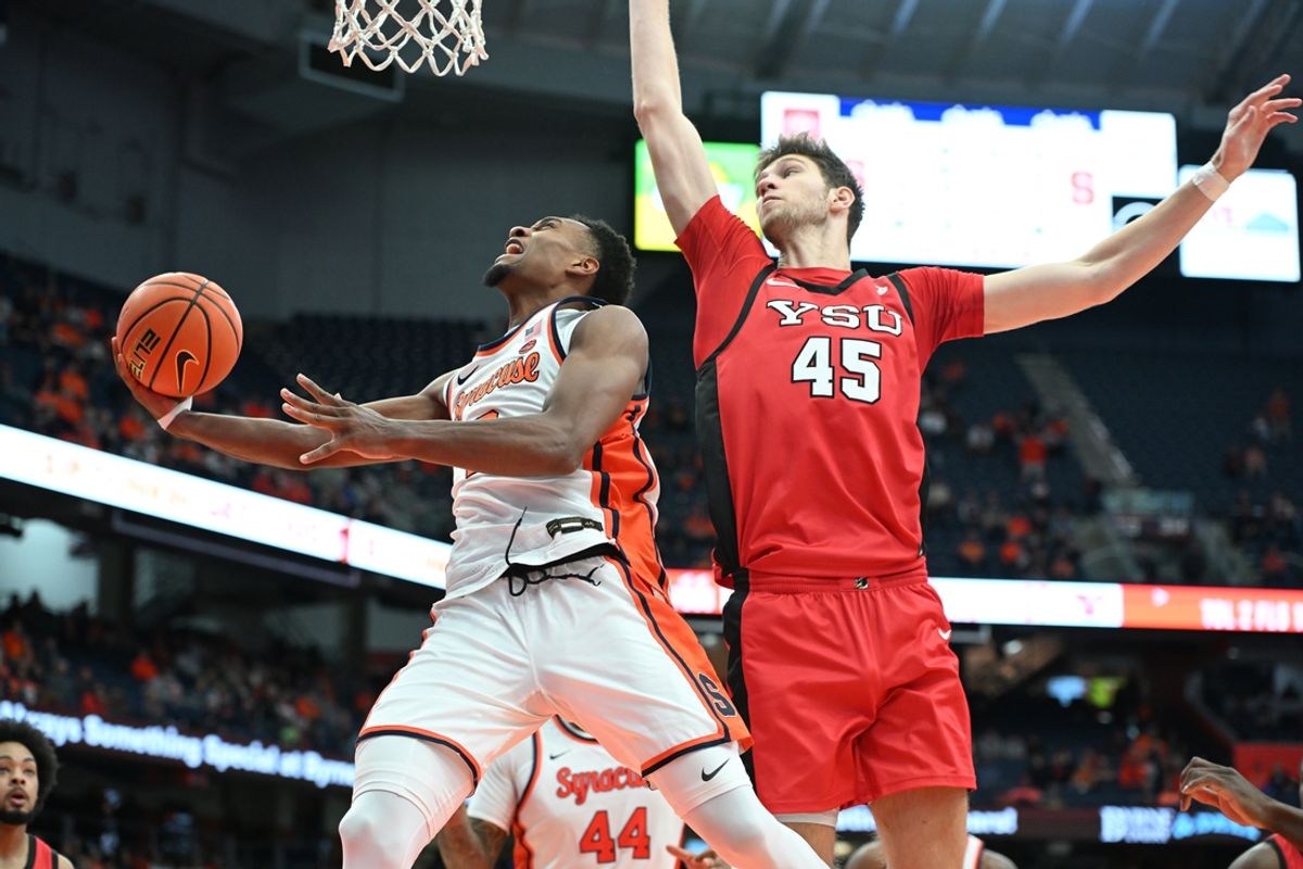 Nov 16, 2024; Syracuse, New York, USA; Syracuse Orange guard J.J. Starling (2) goes for a lay up as Youngstown State Penguins center Gabe Dynes (45) defends in the second half at the JMA Wireless Dome. Mandatory Credit: Mark Konezny-Imagn Images
