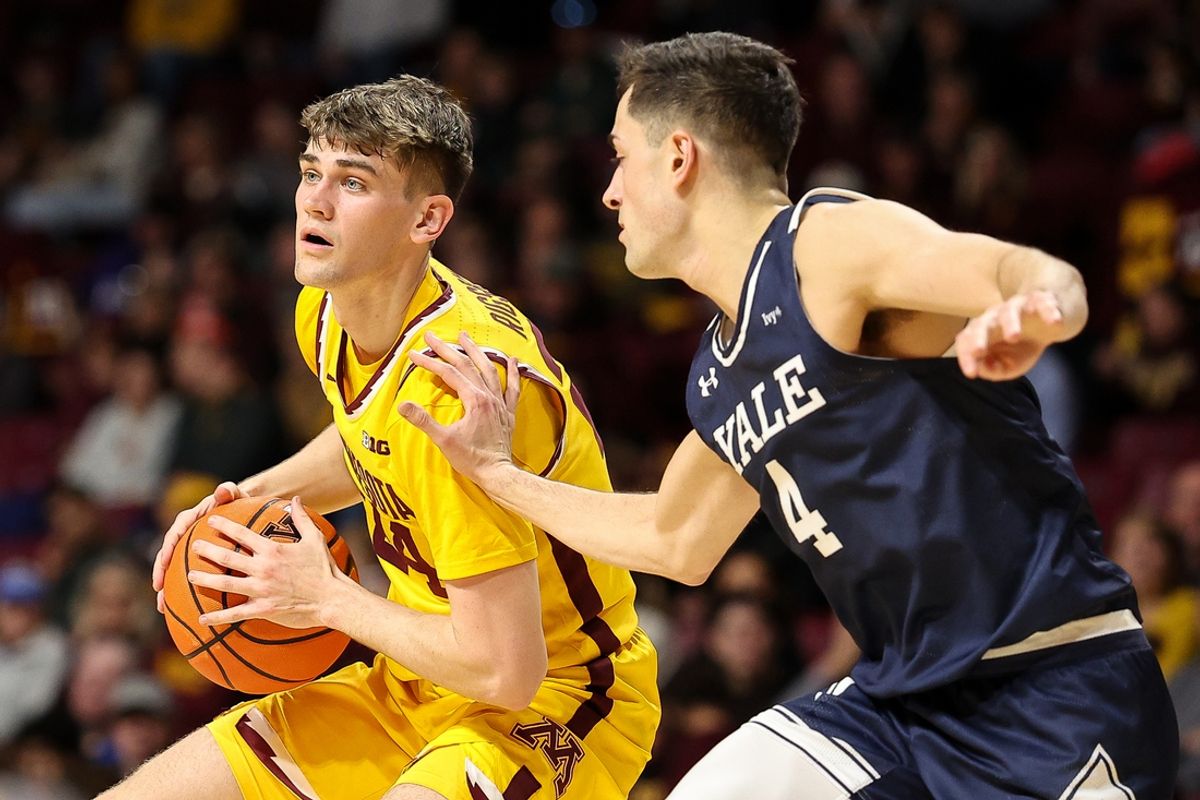 Nov 16, 2024; Minneapolis, Minnesota, USA; Minnesota Golden Gophers guard Brennan Rigsby (24) dribbles as Yale Bulldogs guard John Poulakidas (4) defends during the first half at Williams Arena. Mandatory Credit: Matt Krohn-Imagn Images