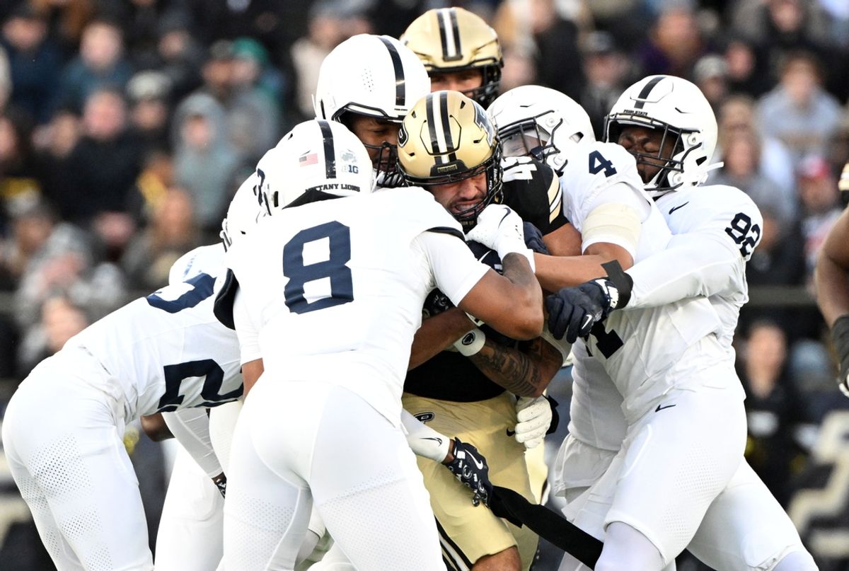 Nov 16, 2024; West Lafayette, Indiana, USA; Purdue Boilermakers running back Devin Mockobee (45) is tackled by several Penn State Nittany Lions during the second quarter at Ross-Ade Stadium. Mandatory Credit: Marc Lebryk-Imagn Images