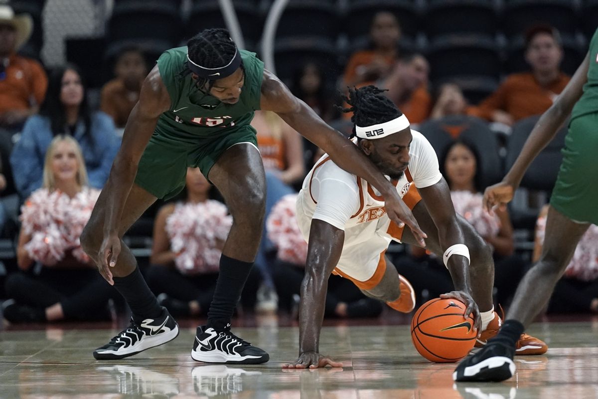 Nov 16, 2024; Austin, Texas, USA; Texas Longhorns forward Arthur Kaluma (6) and Mississippi Valley State Delta Devils Mississippi Valley State Delta Devils forward Alvin Stredic (15) dive for the ball at Moody Center. Mandatory Credit: Scott Wachter-Imagn Images
