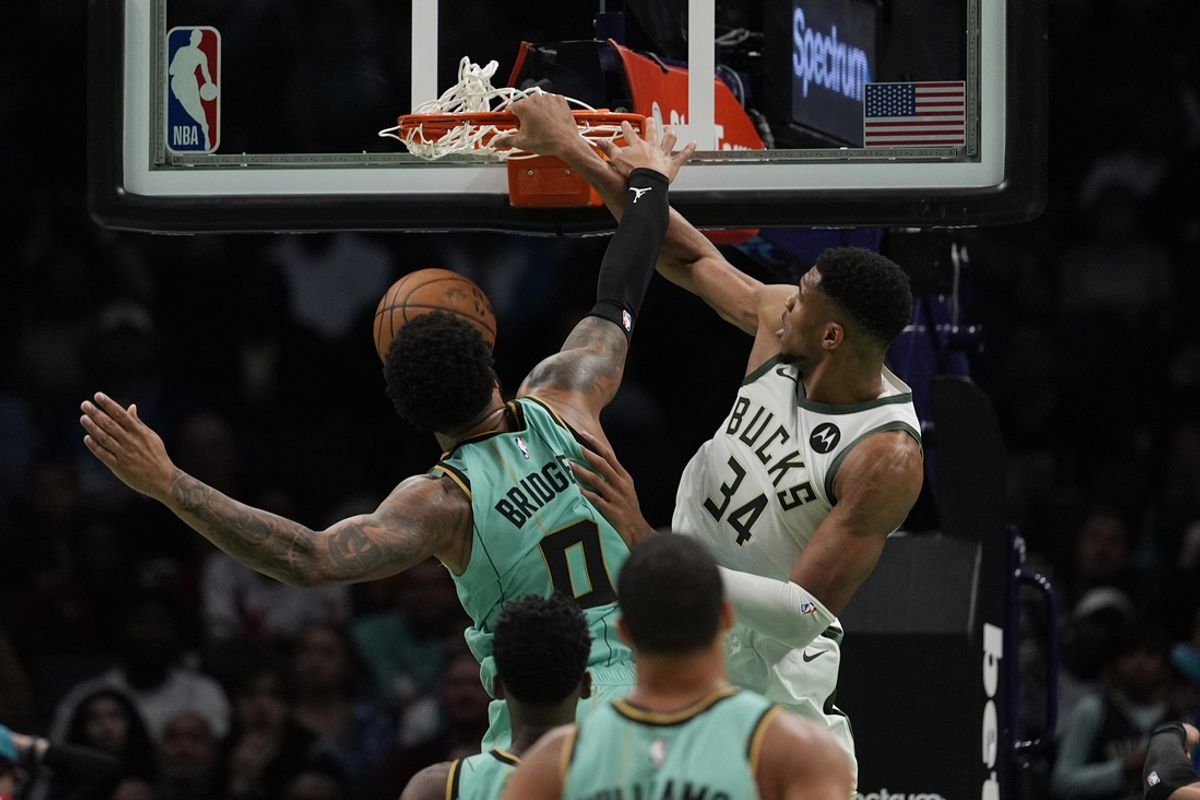 Nov 16, 2024; Charlotte, North Carolina, USA;  Milwaukee Bucks forward Giannis Antetokounmpo (34) gets a dunk Charlotte Hornets forward Miles Bridges (0) during the second half at Spectrum Center. Mandatory Credit: Jim Dedmon-Imagn Images