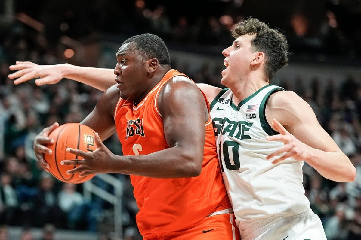 Bowling Green forward Marcus Johnson (6) grabs a rebound against Michigan State center Szymon Zapala (10) during the first half at Breslin Center in East Lansing on Saturday, Nov. 16, 2024.
