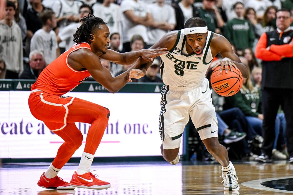 Michigan State's Tre Holloman, right, moves the ball as Bowling Green's Javontae Campbell defends during the second half on Saturday, Nov. 16, 2024, Breslin Center in East Lansing.