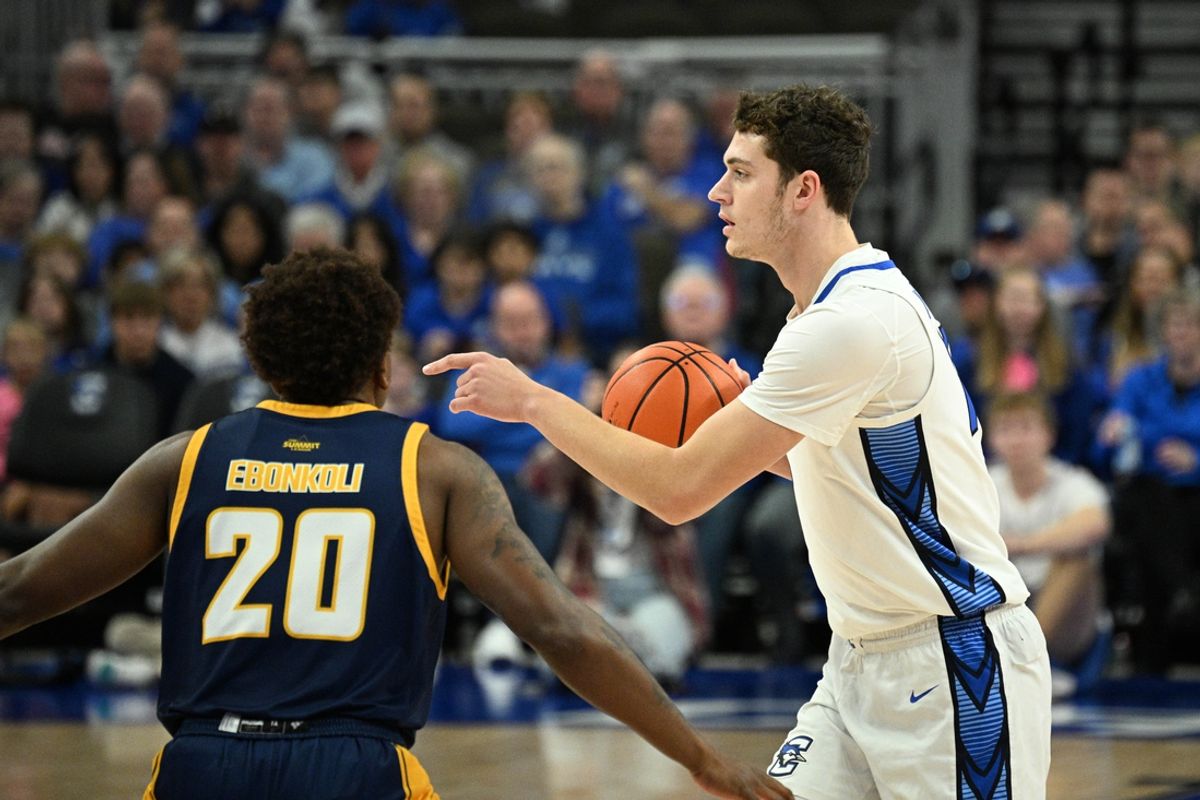 Nov 16, 2024; Omaha, Nebraska, USA;  Creighton Bluejays center Ryan Kalkbrenner (11) controls the ball against UMKC Kangaroos center Melvyn Ebonkoli (20) in the first half at CHI Health Center Omaha. Mandatory Credit: Steven Branscombe-Imagn Images