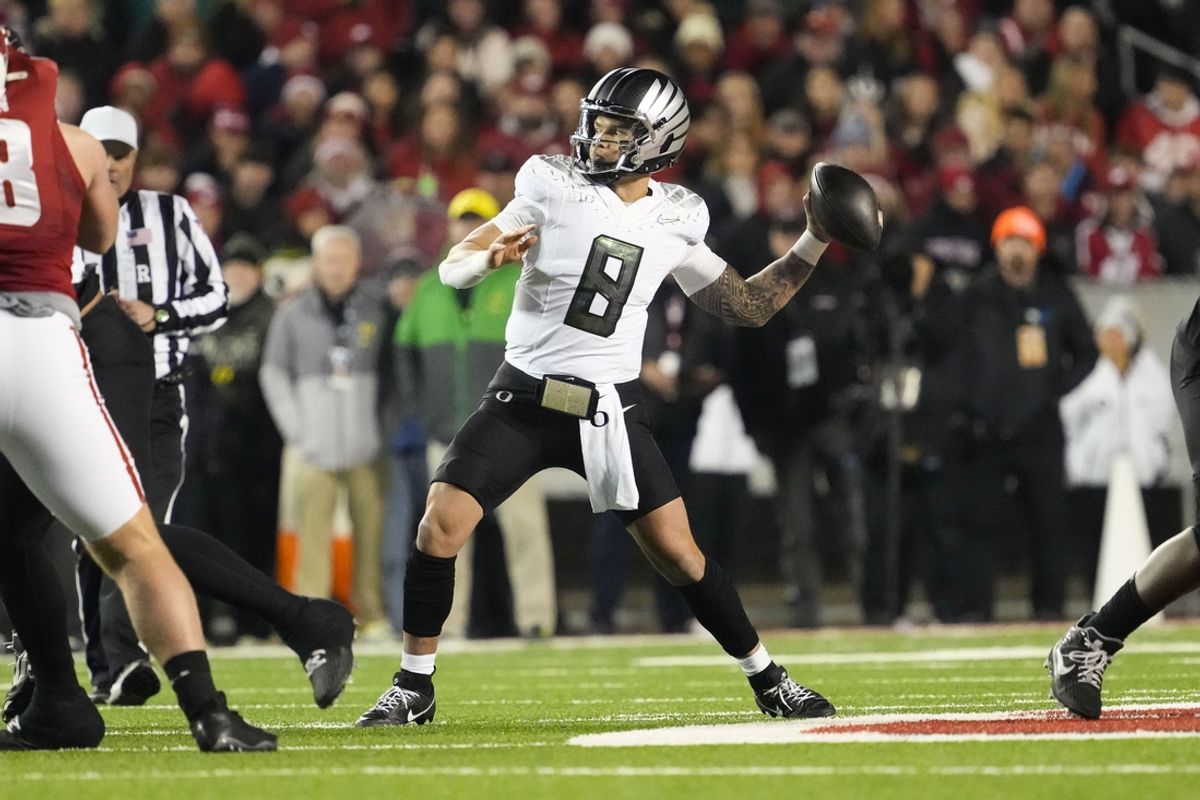 Nov 16, 2024; Madison, Wisconsin, USA;  Oregon Ducks quarterback Dillon Gabriel (8) throws a pass during the first quarter against the Wisconsin Badgers at Camp Randall Stadium. Mandatory Credit: Jeff Hanisch-Imagn Images
