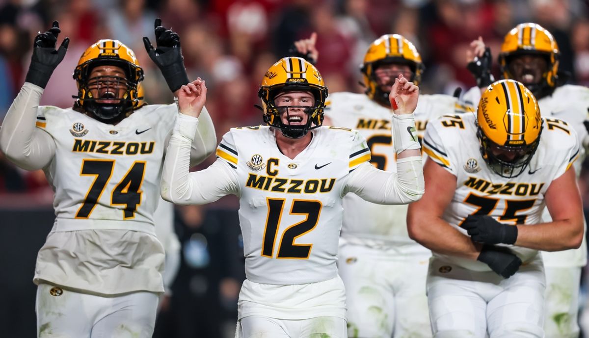 Nov 16, 2024; Columbia, South Carolina, USA; Missouri Tigers quarterback Brady Cook (12) and teammates celebrate after a touchdown against the South Carolina Gamecocks in the second half at Williams-Brice Stadium. Mandatory Credit: Jeff Blake-Imagn Images