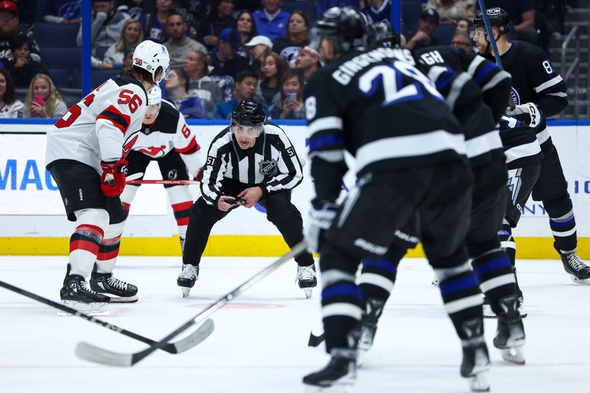 Nov 16, 2024; Tampa, Florida, USA; linesman Andrew Smith (51) gets ready to drop the puck during a game between the New Jersey Devils and Tampa Bay Lightning in the second period at Amalie Arena. Mandatory Credit: Nathan Ray Seebeck-Imagn Images