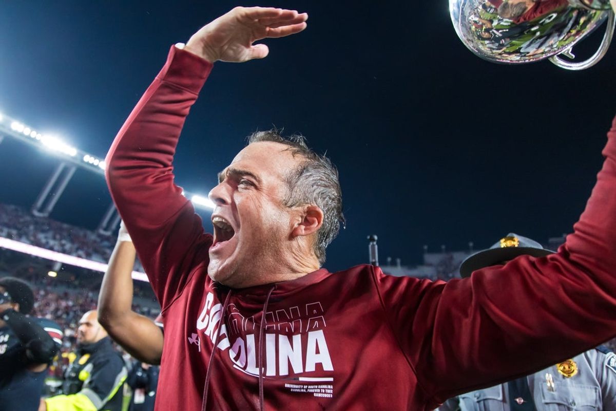 South Carolina Gamecocks head coach Shane Beamer celebrates beating the Missouri Tigers at Williams-Brice Stadium. He is holding the Mayors Cup, given to the winner of the South Carolina-Missouri game. Mandatory Credit: Jeff Blake-Imagn Images