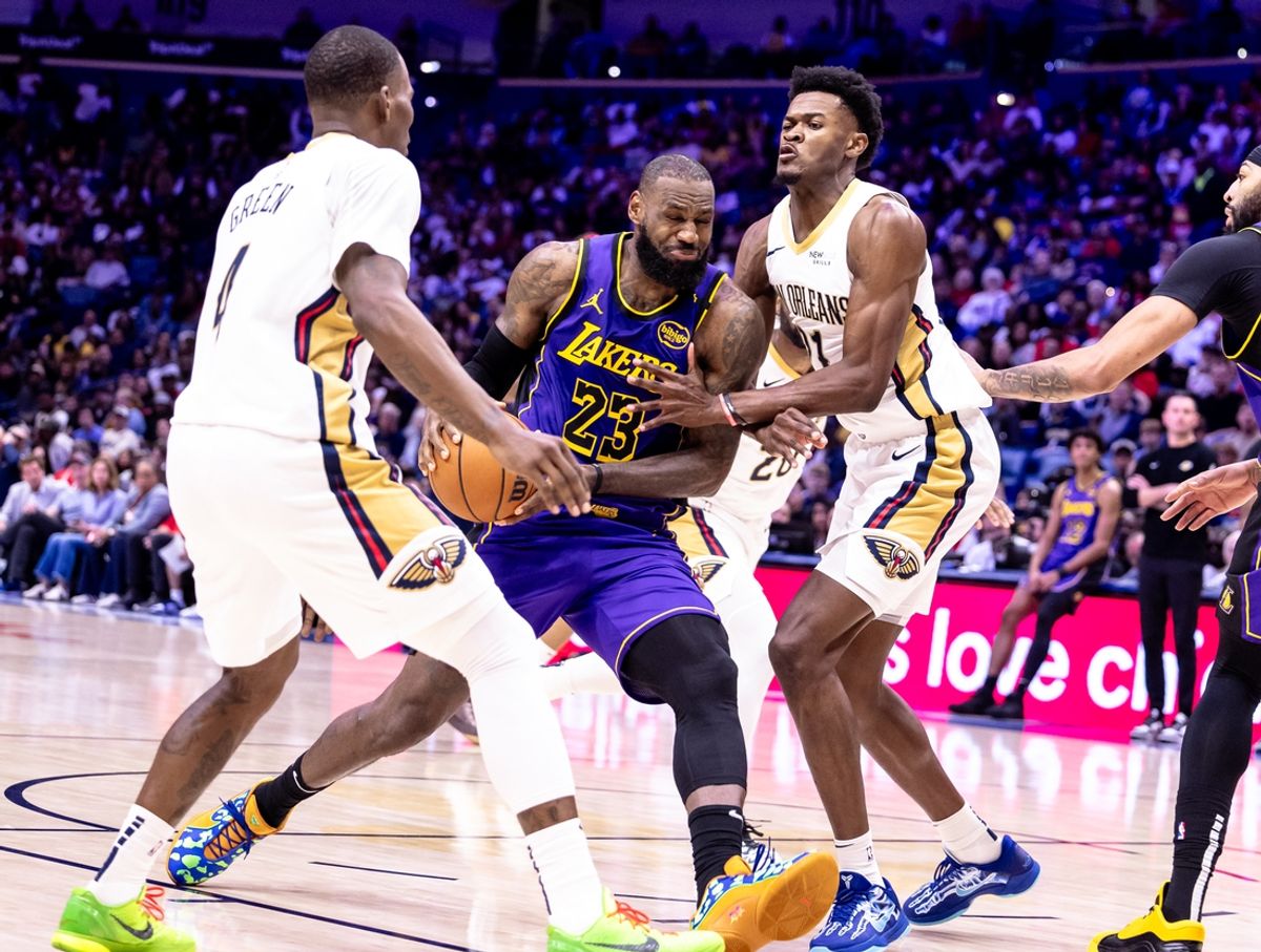 Nov 16, 2024; New Orleans, Louisiana, USA;  Los Angeles Lakers forward LeBron James (23) dribbles against New Orleans Pelicans center Yves Missi (21) and guard Javonte Green (4) during the first half at Smoothie King Center. Mandatory Credit: Stephen Lew-Imagn Images