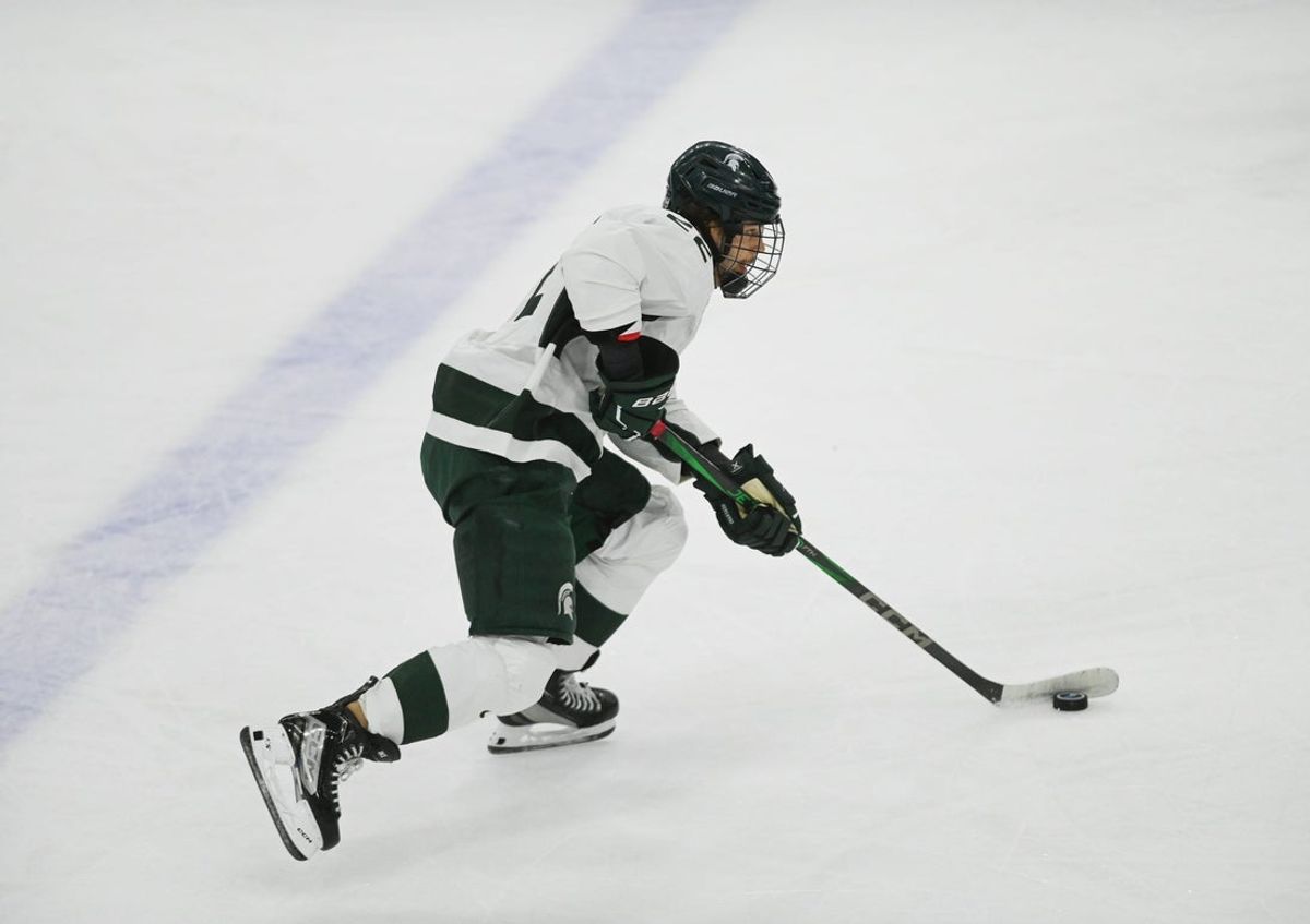 Isaac Howard of MSU moves the puck against Notre Dame, Saturday, Nov. 15, 2024, at Munn Ice Arena. MSU won 4-3 to sweep the series.