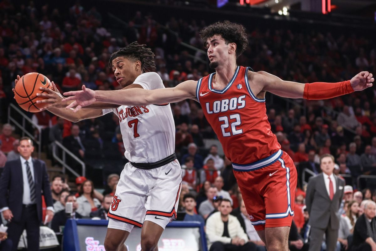 Nov 17, 2024; New York, New York, USA; St. John's Red Storm guard Simeon Wilcher (7) and New Mexico Lobos forward Mustapha Amzil (22) fight for a loose ball in the first half at Madison Square Garden. Mandatory Credit: Wendell Cruz-Imagn Images