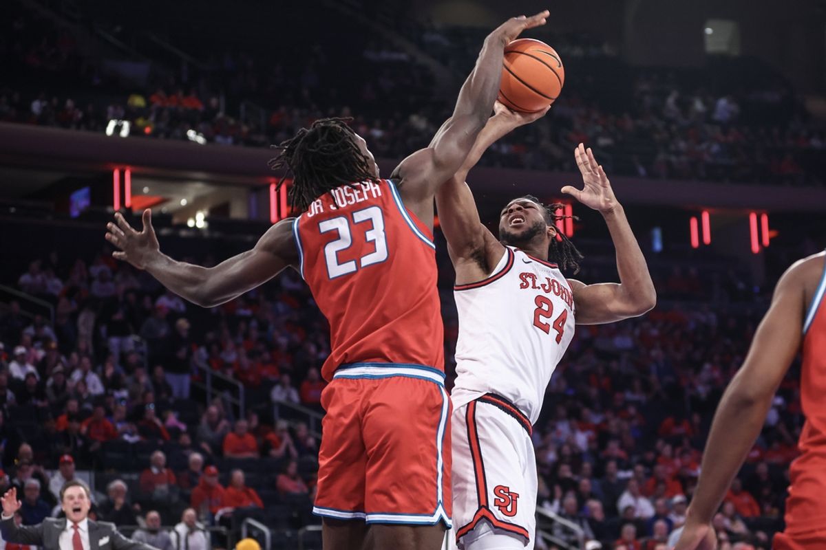 Nov 17, 2024; New York, New York, USA;  St. John's Red Storm forward Zuby Ejiofor (24) shoots over New Mexico Lobos center Nelly Junior Joseph (23) in the second half at Madison Square Garden. Mandatory Credit: Wendell Cruz-Imagn Images