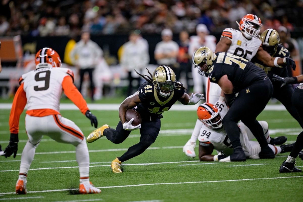 Nov 17, 2024; New Orleans, Louisiana, USA; New Orleans Saints running back Alvin Kamara (41) runs against Cleveland Browns safety Grant Delpit (9) and defensive tackle Dalvin Tomlinson (94) during the second quarter at Caesars Superdome. Mandatory Credit: Matthew Hinton-Imagn Images