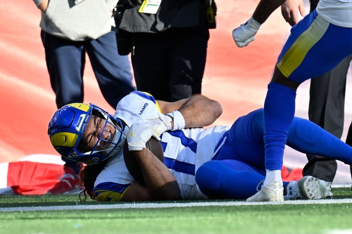 Nov 17, 2024; Foxborough, Massachusetts, USA;  Los Angeles Rams wide receiver Puka Nacua (17) reacts in pain after scoring a touchdown against the New England Patriots during the first half at Gillette Stadium. Mandatory Credit: Eric Canha-Imagn Images