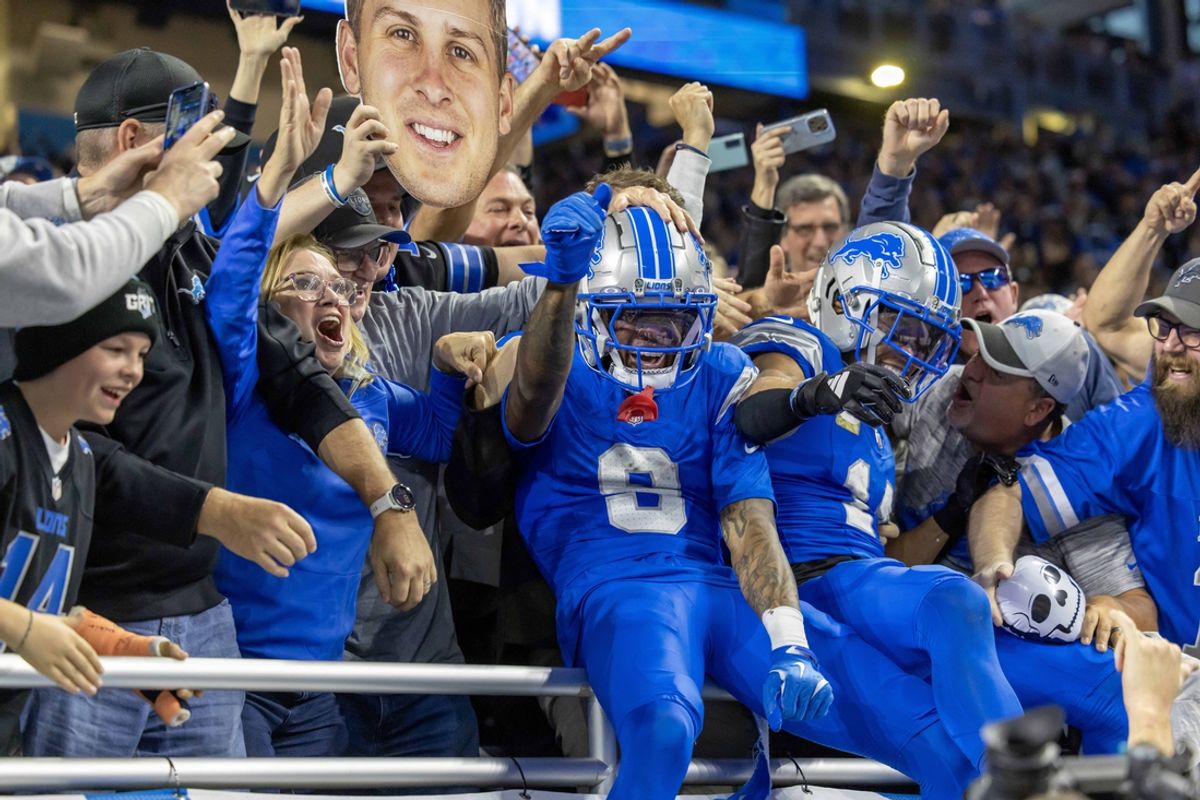 Nov 17, 2024; Detroit, Michigan, USA; Detroit Lions wide receiver Amon-Ra St. Brown (14) and wide receiver Jameson Williams (9) jump into the seat and celebrate St Brown’s touchdown against the Jacksonville Jaguars during the second half at Ford Field. Mandatory Credit: David Reginek-Imagn Images