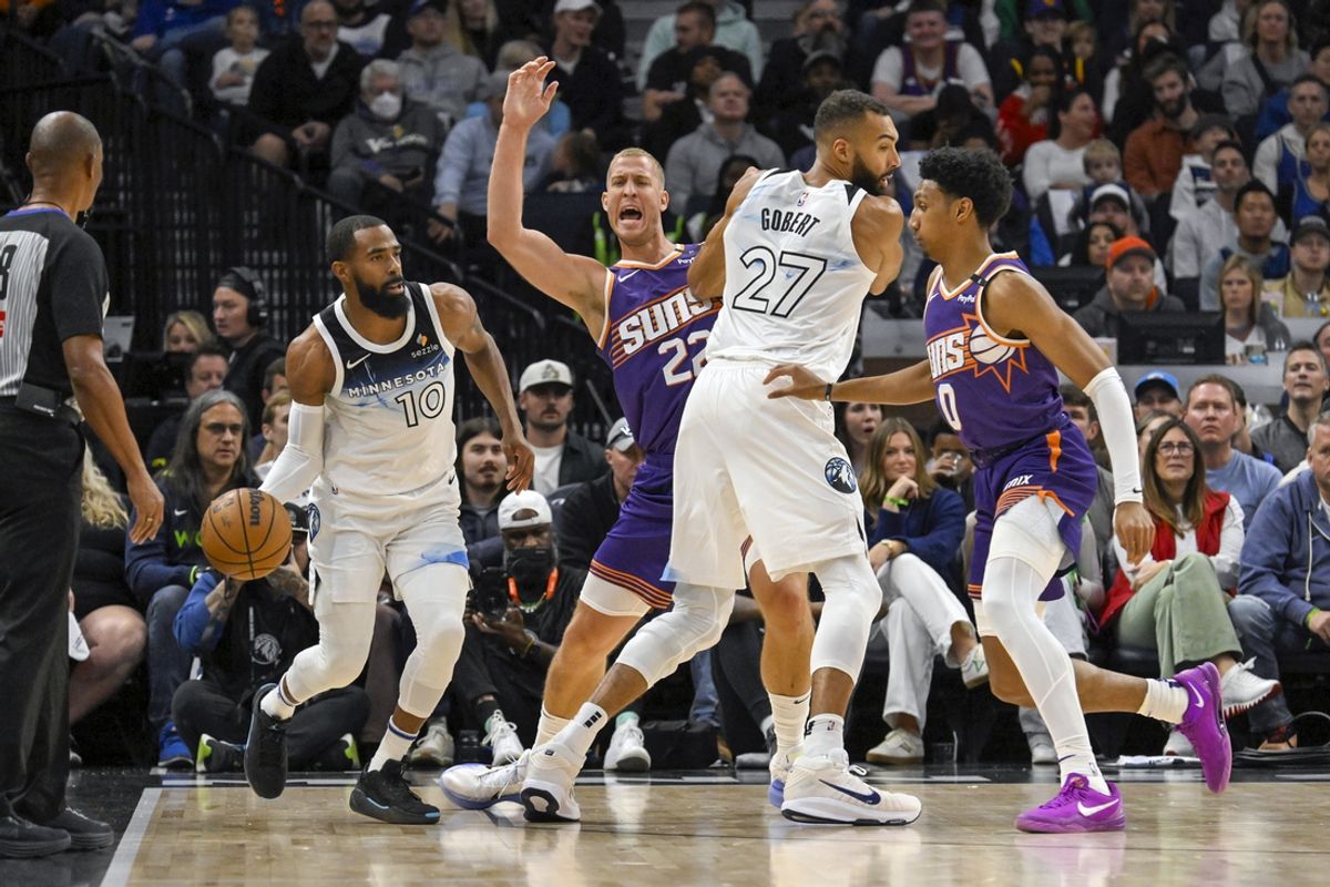 Nov 17, 2024; Minneapolis, Minnesota, USA; Minnesota Timberwolves center Rudy Gobert (27) sets a pick on Phoenix Suns center Mason Plumlee (22) for guard Mike Conley (10) as forward Royce O'Neale (0) gives chase during the first quarter at Target Center. Mandatory Credit: Nick Wosika-Imagn Images
