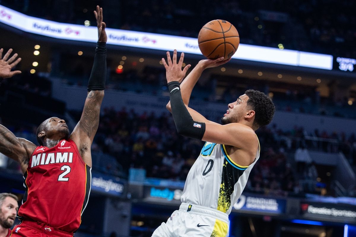 Nov 17, 2024; Indianapolis, Indiana, USA; Indiana Pacers guard Tyrese Haliburton (0) shoots the ball while Miami Heat guard Terry Rozier (2) defends in the first quarter at Gainbridge Fieldhouse. Mandatory Credit: Trevor Ruszkowski-Imagn Images