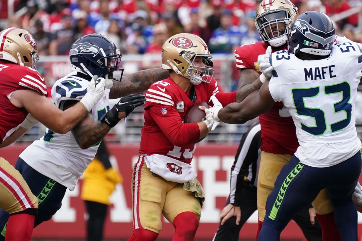 Nov 17, 2024; Santa Clara, California, USA; Seattle Seahawks defensive end Dre'Mont Jones (55) sacks San Francisco 49ers quarterback Brock Purdy (13) in the second quarter at Levi's Stadium. Mandatory Credit: David Gonzales-Imagn Images