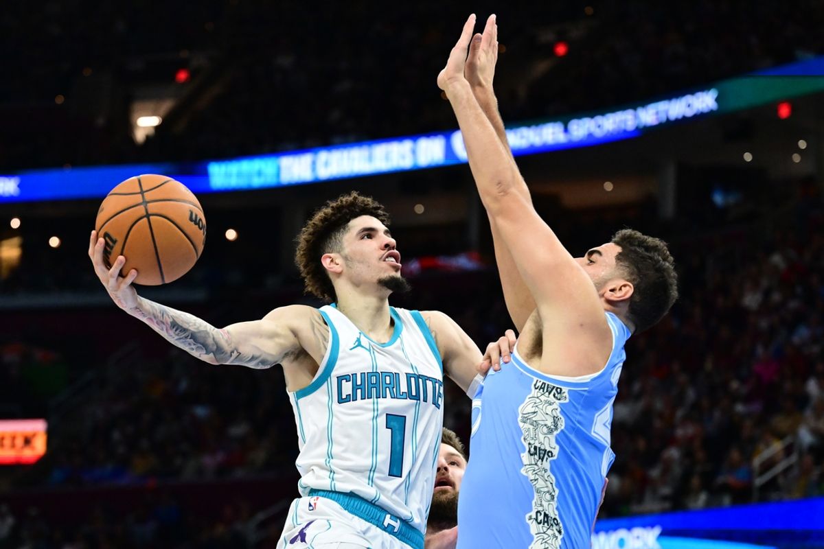 Nov 17, 2024; Cleveland, Ohio, USA; Charlotte Hornets guard LaMelo Ball (1) drives to the basket against Cleveland Cavaliers forward Georges Niang (20) during the first half at Rocket Mortgage FieldHouse. Mandatory Credit: Ken Blaze-Imagn Images