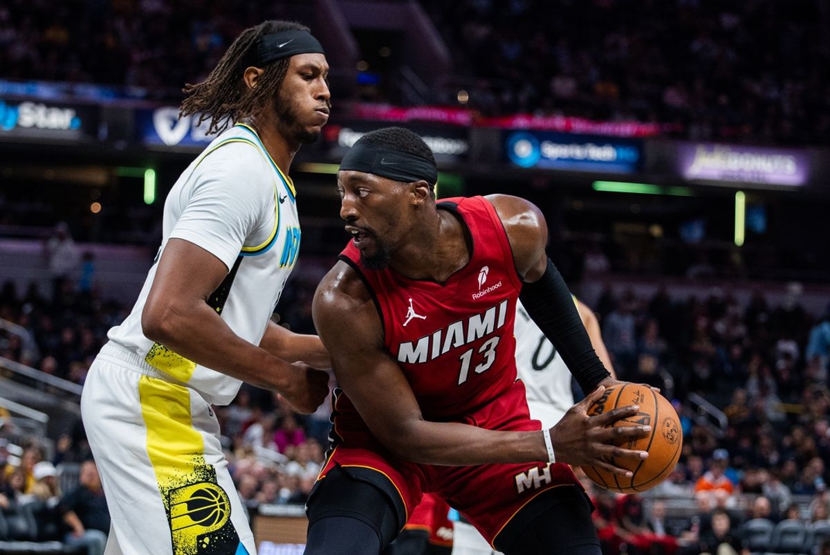 Nov 17, 2024; Indianapolis, Indiana, USA; Miami Heat center Bam Adebayo (13) holds the ball while Indiana Pacers center Myles Turner (33) defends in the second half at Gainbridge Fieldhouse. Mandatory Credit: Trevor Ruszkowski-Imagn Images