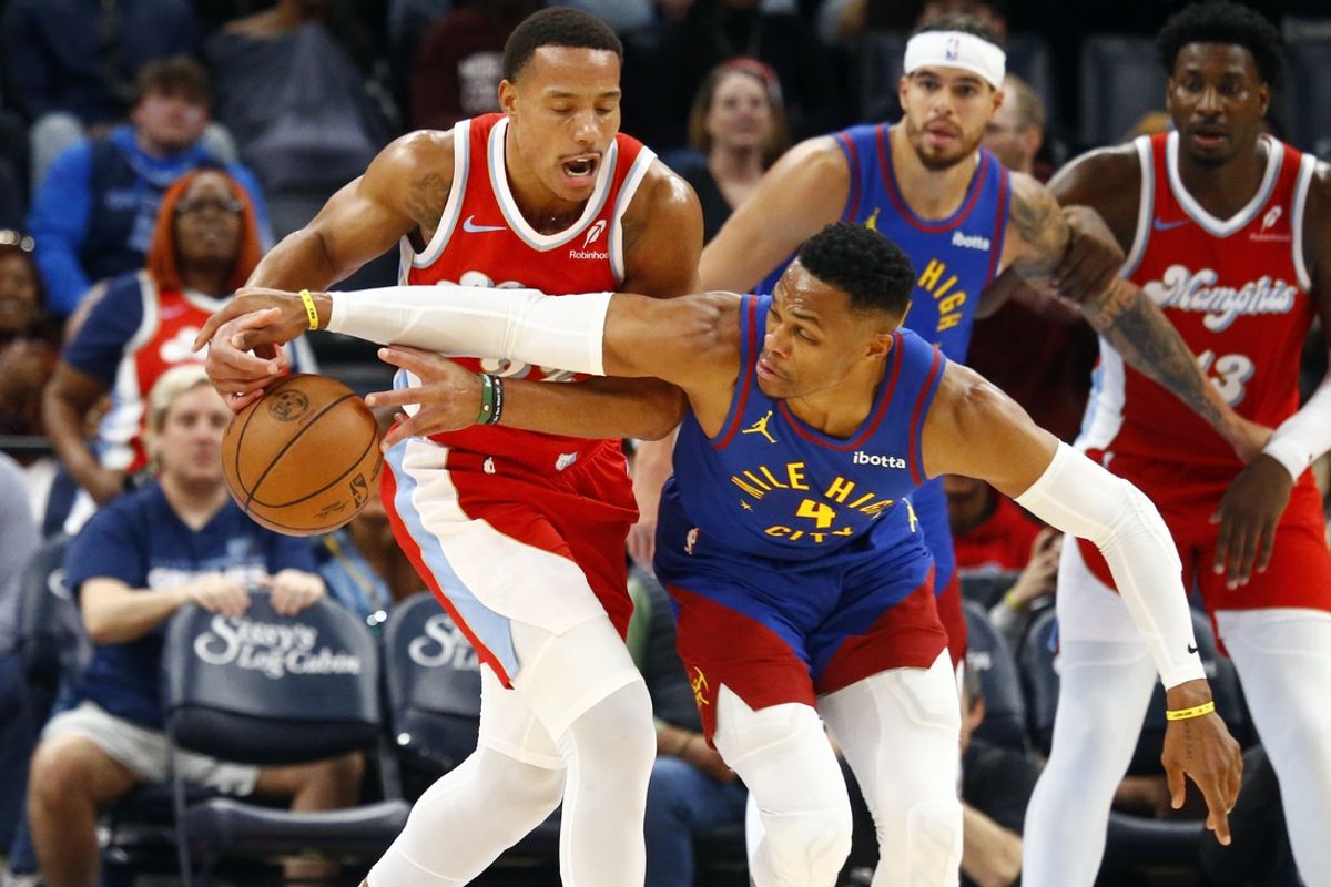 Nov 17, 2024; Memphis, Tennessee, USA; Memphis Grizzlies guard Desmond Bane (22) and Denver Nuggets guard Russell Westbrook (4) battle for a loose ball during the first half at FedExForum. Mandatory Credit: Petre Thomas-Imagn Images