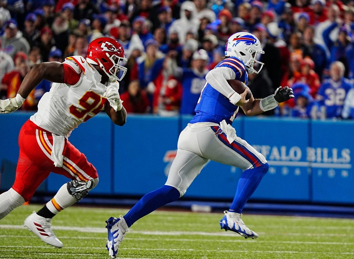 Bills quarterback Josh Allen carries the ball for several yards before sliding to avoid a tackle during first half action against the Kansas City Chiefs in Orchard Park, Nov.17, 2024. Chasing him is Kansas City's Cameron Thomas.