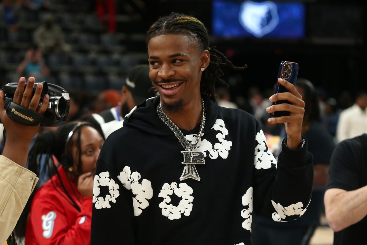 Nov 17, 2024; Memphis, Tennessee, USA; Memphis Grizzlies guard Ja Morant (12) takes videos with his phone after the game against the Denver Nuggets at FedExForum. Mandatory Credit: Petre Thomas-Imagn Images