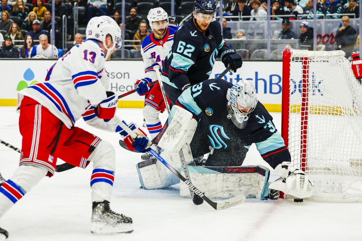 Nov 17, 2024; Seattle, Washington, USA; Seattle Kraken goaltender Philipp Grubauer (31) makes a save against New York Rangers left wing Alexis Lafrenière (13) during the second period at Climate Pledge Arena. Seattle Kraken defenseman Brandon Montour (62) follows the play behind Grubauer. Mandatory Credit: Joe Nicholson-Imagn Images