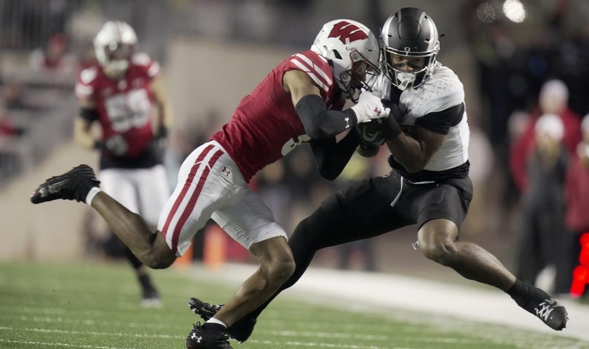 Nov 16, 2024; Madison, Wisconsin, USA; Wisconsin Badgers cornerback Nyzier Fourqurean (3) tackles tight end Kenyon Sadiq (18) after making reception for a first down during the first quarter at Camp Randall Stadium. Mandatory Credit: Mark Hoffman/USA TODAY Network via Imagn Images