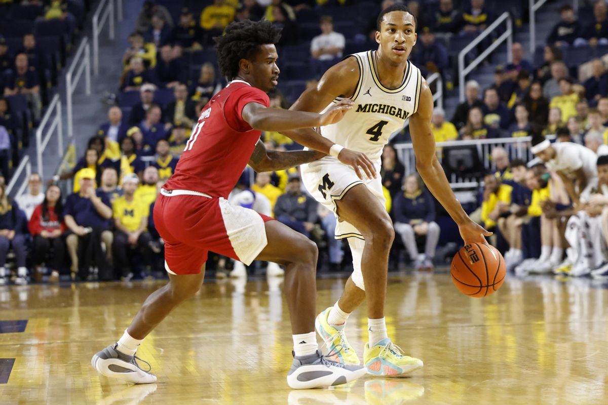 Nov 18, 2024; Ann Arbor, Michigan, USA;  Michigan Wolverines guard Nimari Burnett (4) dribbles defended by Miami (Oh) Redhawks guard Mekhi Cooper (11) in the first half at Crisler Center. Mandatory Credit: Rick Osentoski-Imagn Images
