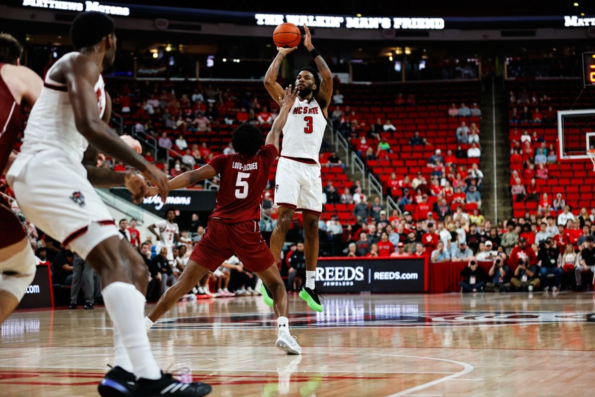 Nov 18, 2024; Raleigh, North Carolina, USA; North Carolina State Wolfpack guard Dontrez Styles (3) shoots a three pointer during first half of the game against the Colgate Raiders at Lenovo Center. Mandatory Credit: Jaylynn Nash-Imagn Images