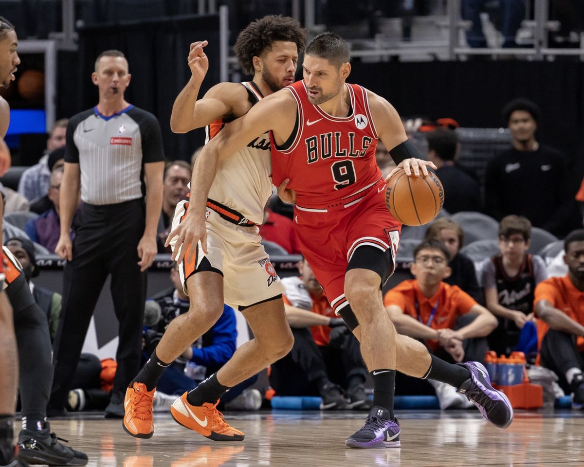 Nov 18, 2024; Detroit, Michigan, USA; Detroit Pistons guard Cade Cunningham (2) defends against Chicago Bulls center Nikola Vucevic (9) during the first half at Little Caesars Arena. Mandatory Credit: David Reginek-Imagn Images