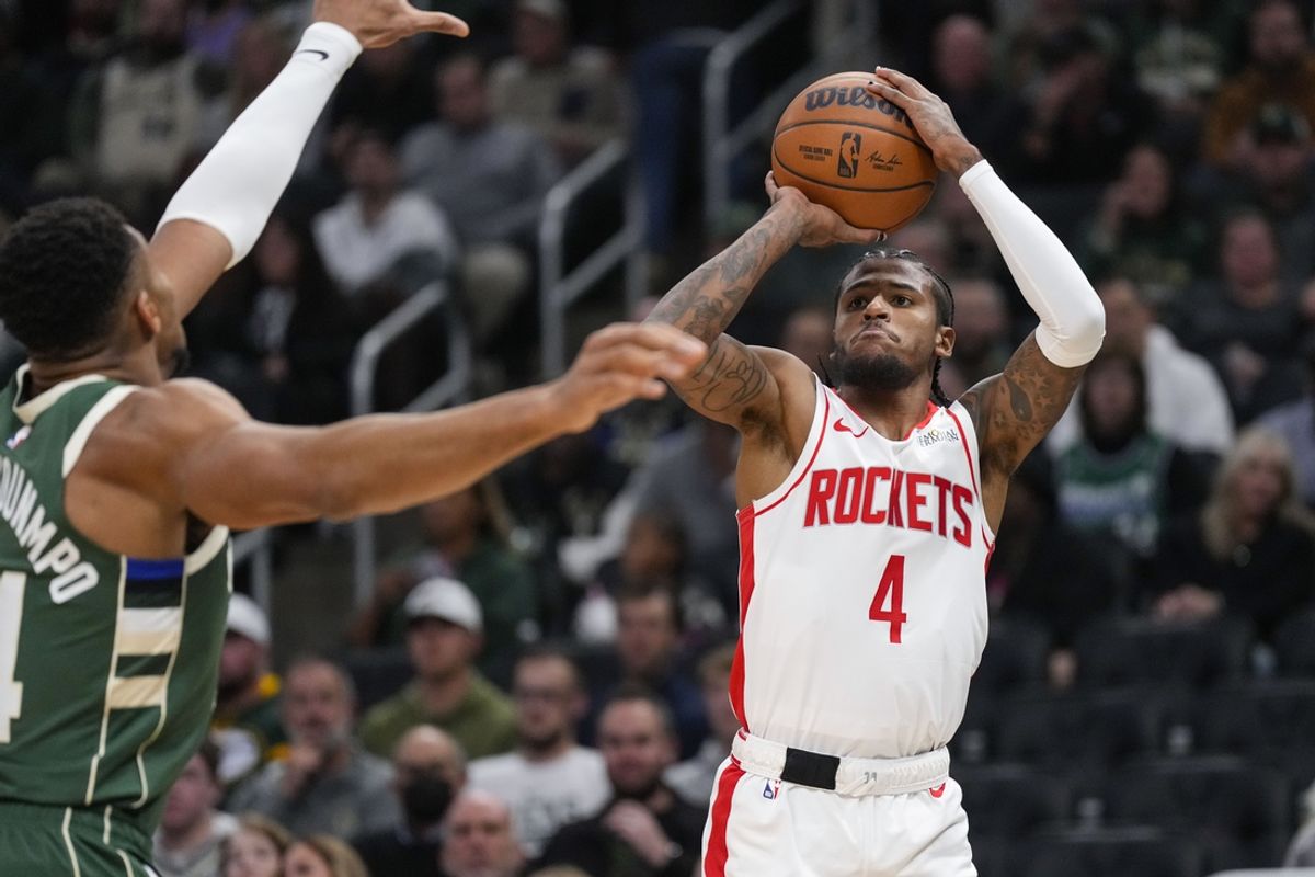 Nov 18, 2024; Milwaukee, Wisconsin, USA;  Houston Rockets guard Jalen Green (4) shoots against Milwaukee Bucks forward Giannis Antetokounmpo (34) during the first quarter at Fiserv Forum. Mandatory Credit: Jeff Hanisch-Imagn Images