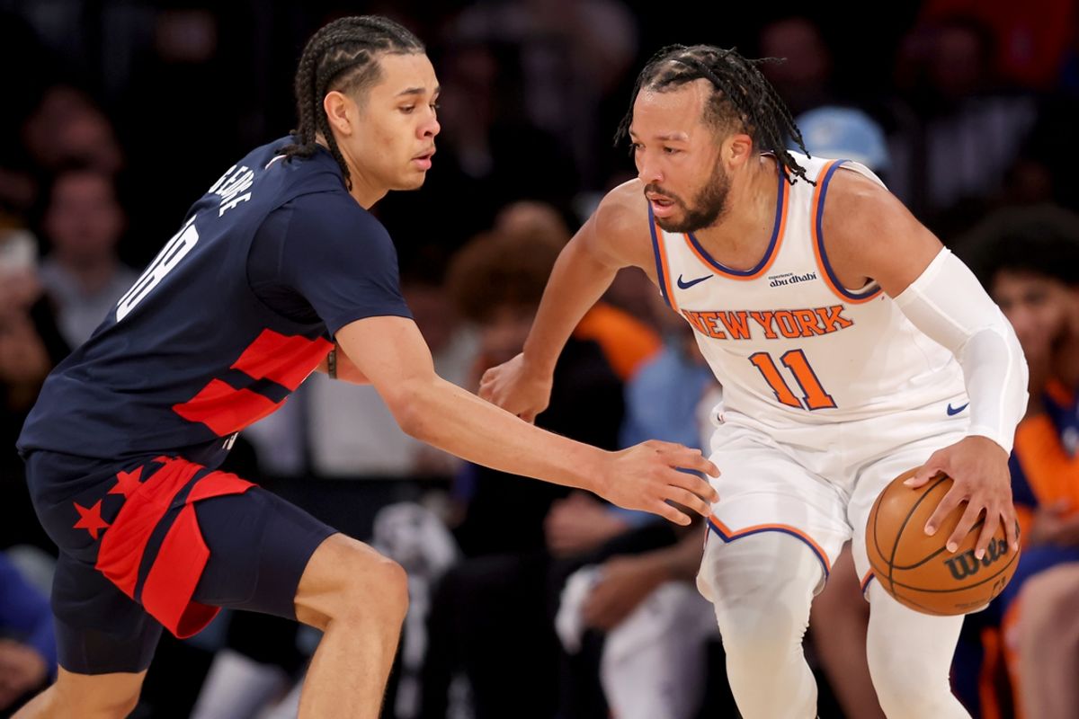 Nov 18, 2024; New York, New York, USA; New York Knicks guard Jalen Brunson (11) controls the ball against Washington Wizards forward Kyshawn George (18) during the second quarter at Madison Square Garden. Mandatory Credit: Brad Penner-Imagn Images