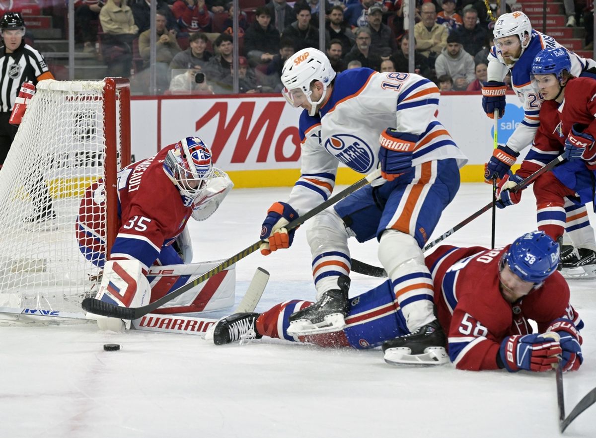 Nov 18, 2024; Montreal, Quebec, CAN; Montreal Canadiens goalie Sam Montembeault (35) stops Edmonton Oilers forward Zach Hyman (18) with the help of teammate defenseman David Savard (58) during the first period at the Bell Centre. Mandatory Credit: Eric Bolte-Imagn Images