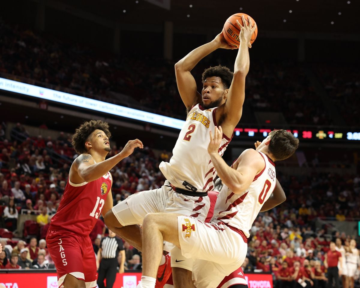 Nov 18, 2024; Ames, Iowa, USA; Iowa State Cyclones forward Joshua Jefferson (2) rebounds over IUPUI Jaguars forward Keenan Garner (13) at James H. Hilton Coliseum. Mandatory Credit: Reese Strickland-Imagn Images