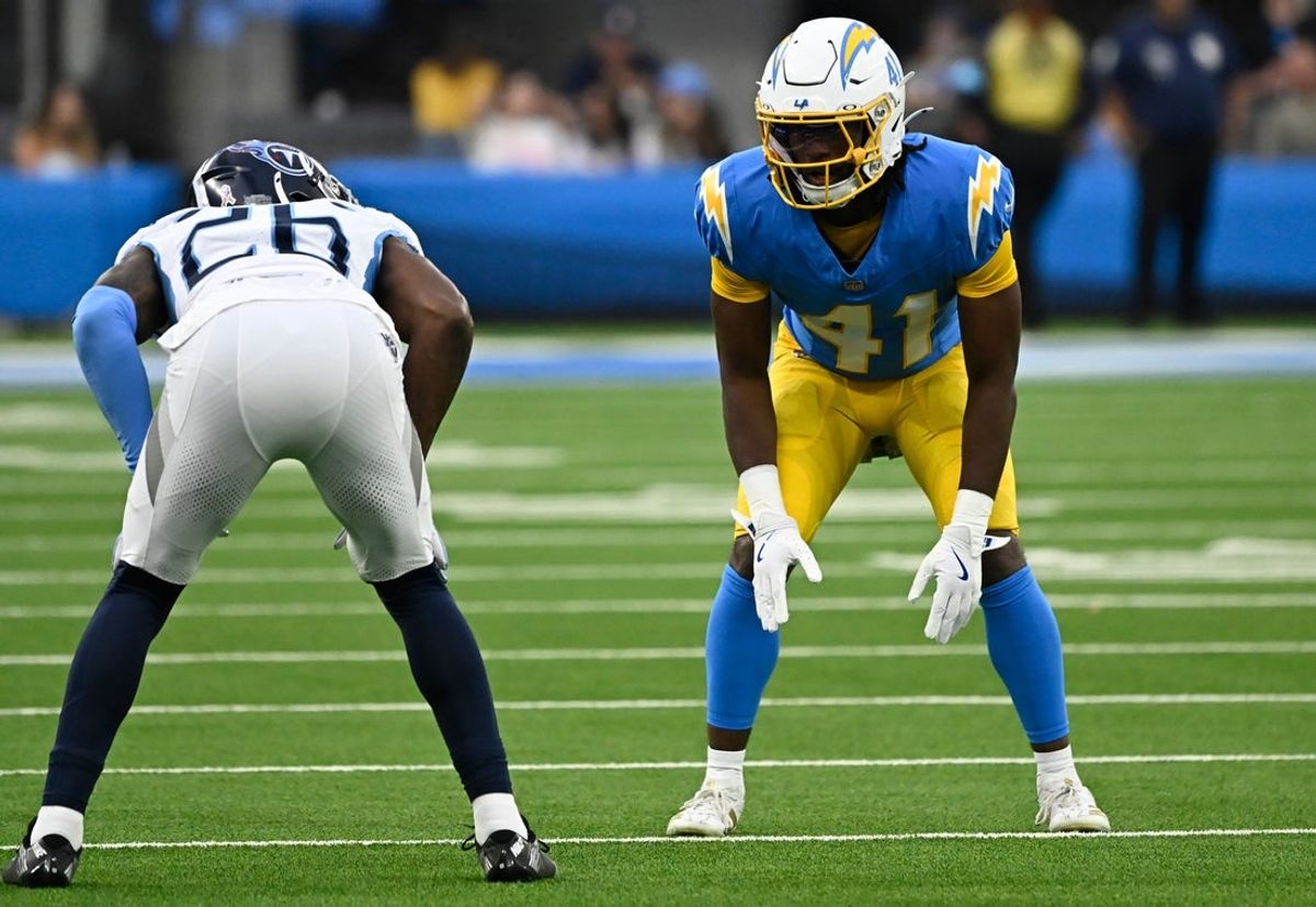 Nov 10, 2024; Inglewood, California, USA; Los Angeles Chargers cornerback Eli Apple (41) and Tennessee Titans cornerback Justin Hardee Sr. (26) during the fourth quarter at SoFi Stadium. Mandatory Credit: Robert Hanashiro-Imagn Images