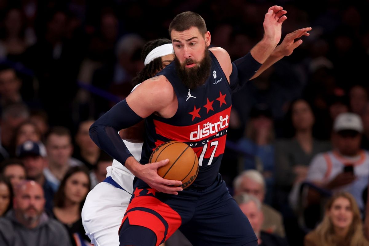 Nov 18, 2024; New York, New York, USA; Washington Wizards center Jonas Valanciunas (17) spins to the basket against New York Knicks center Jericho Sims (20) during the third quarter at Madison Square Garden. Mandatory Credit: Brad Penner-Imagn Images