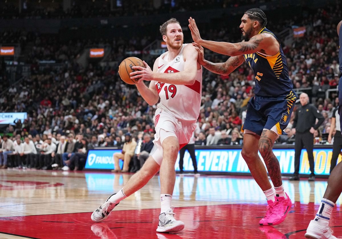 Nov 18, 2024; Toronto, Ontario, CAN; Toronto Raptors center Jakob Poeltl (19) drives to the basket as Indiana Pacers forward Obi Toppin (1) tries to defend during the third quarter at Scotiabank Arena. Mandatory Credit: Nick Turchiaro-Imagn Images