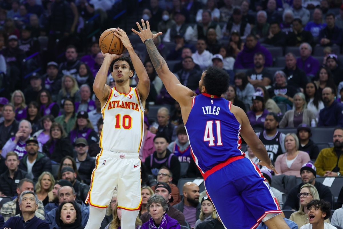 Nov 18, 2024; Sacramento, California, USA; Atlanta Hawks forward Zaccharie Risacher (10) shoots the ball against Sacramento Kings forward Trey Lyles (41) during the first quarter at Golden 1 Center. Mandatory Credit: Sergio Estrada-Imagn Images