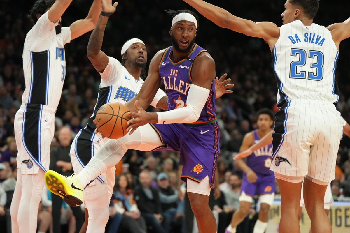 Nov 18, 2024; Phoenix, Arizona, USA; Phoenix Suns forward Josh Okogie (2) looks to pass around Orlando Magic forward Tristan da Silva (23) during the first half of an NBA game at Footprint Center. Mandatory Credit: Rick Scuteri-Imagn Images