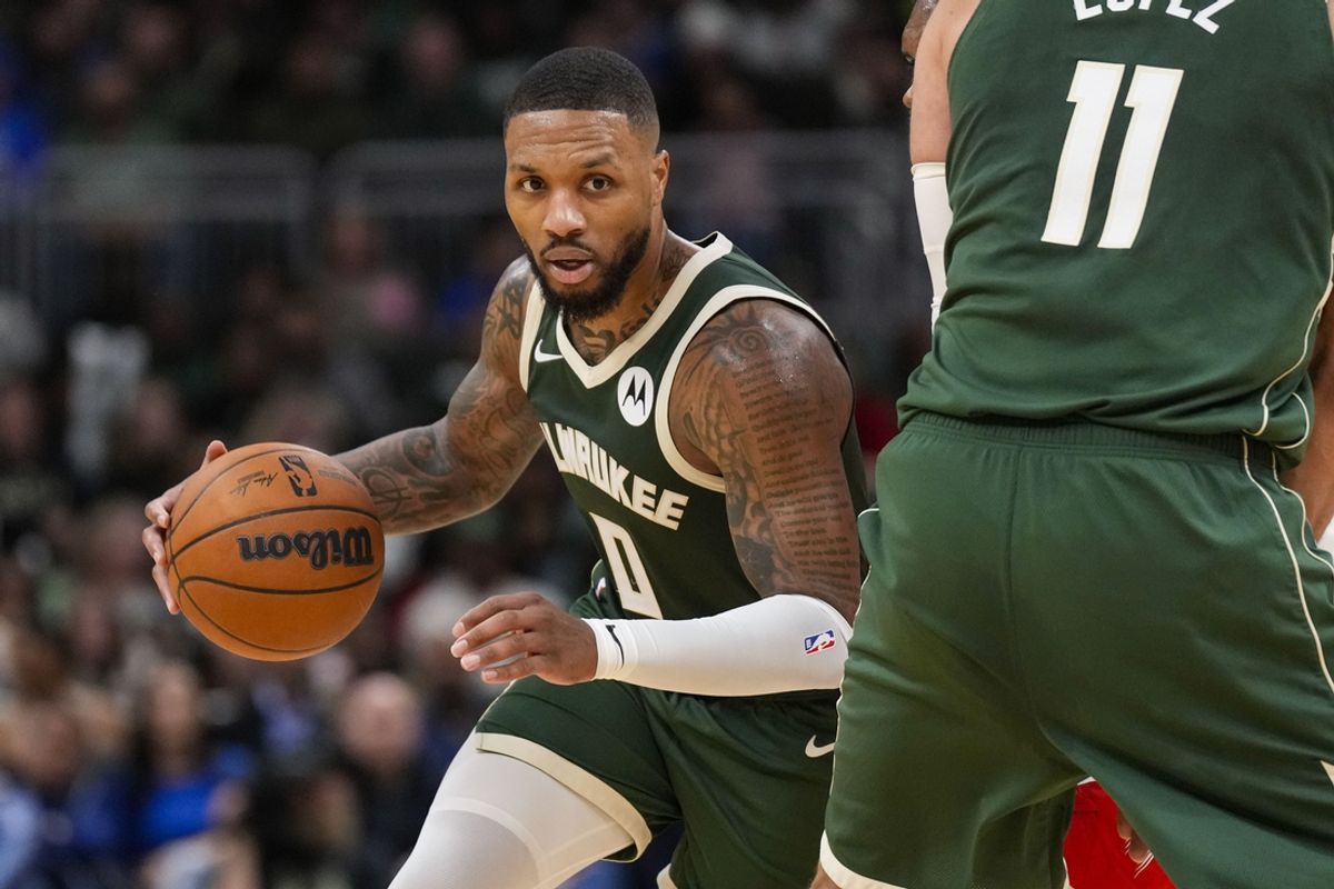 Nov 18, 2024; Milwaukee, Wisconsin, USA;  Milwaukee Bucks guard Damian Lillard (0) drives towards the basket around center Brook Lopez (11) during the fourth quarter against the Houston Rockets at Fiserv Forum. Mandatory Credit: Jeff Hanisch-Imagn Images