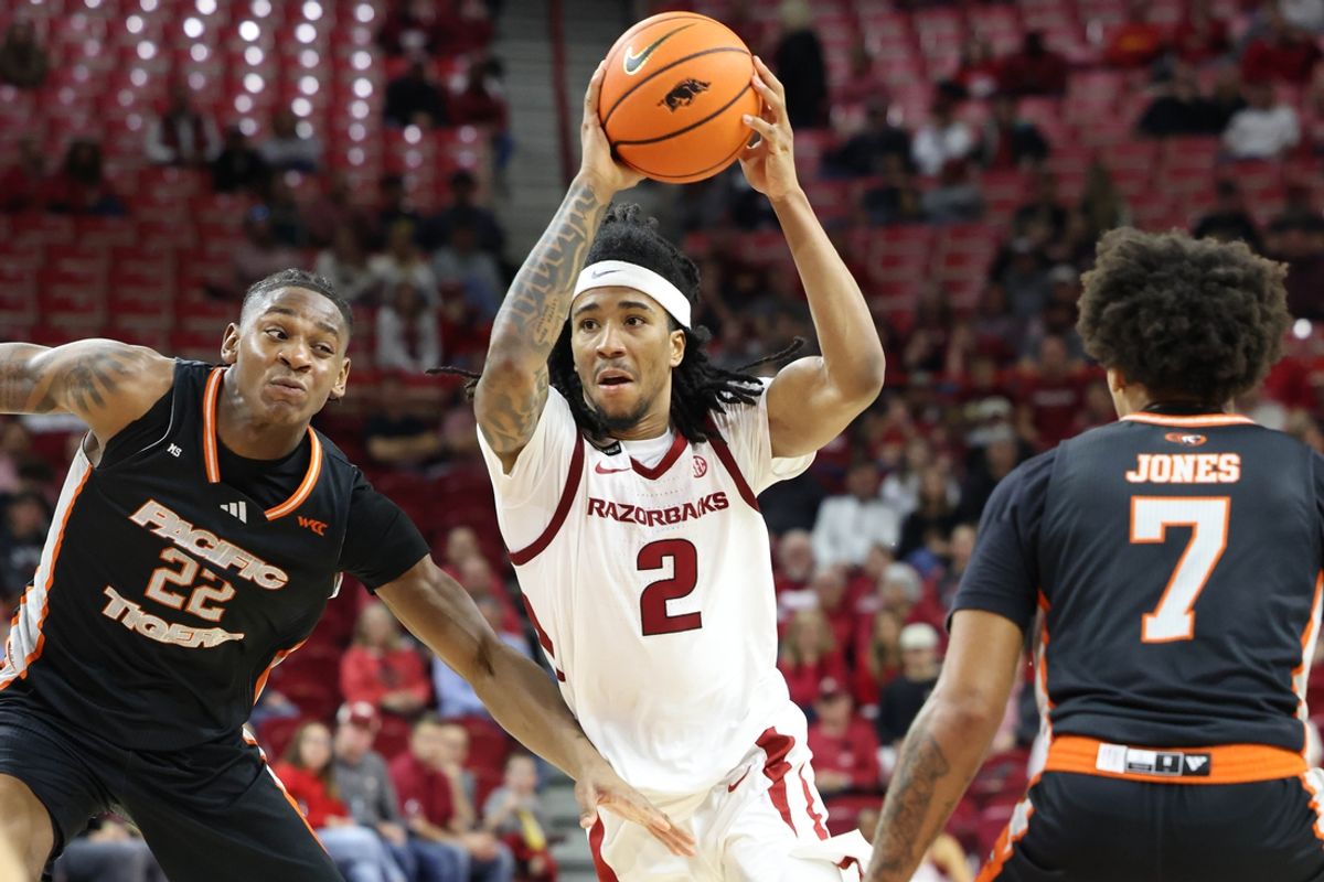 Nov 18, 2024; Fayetteville, Arkansas, USA; Arkansas Razorbacks guard Boogie Fland (2) drives against Pacific Tigers guard Elijah Fisher (22) during the second half at Bud Walton Arena. Arkansas won 91-72. Mandatory Credit: Nelson Chenault-Imagn Images