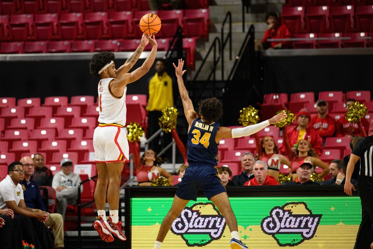Nov 19, 2024; College Park, Maryland, USA; Maryland Terrapins guard Rodney Rice (1) takes a jump shot against Canisius Golden Griffins guard Paul McMillan IV (34) during the first half at Xfinity Center. Mandatory Credit: Reggie Hildred-Imagn Images
