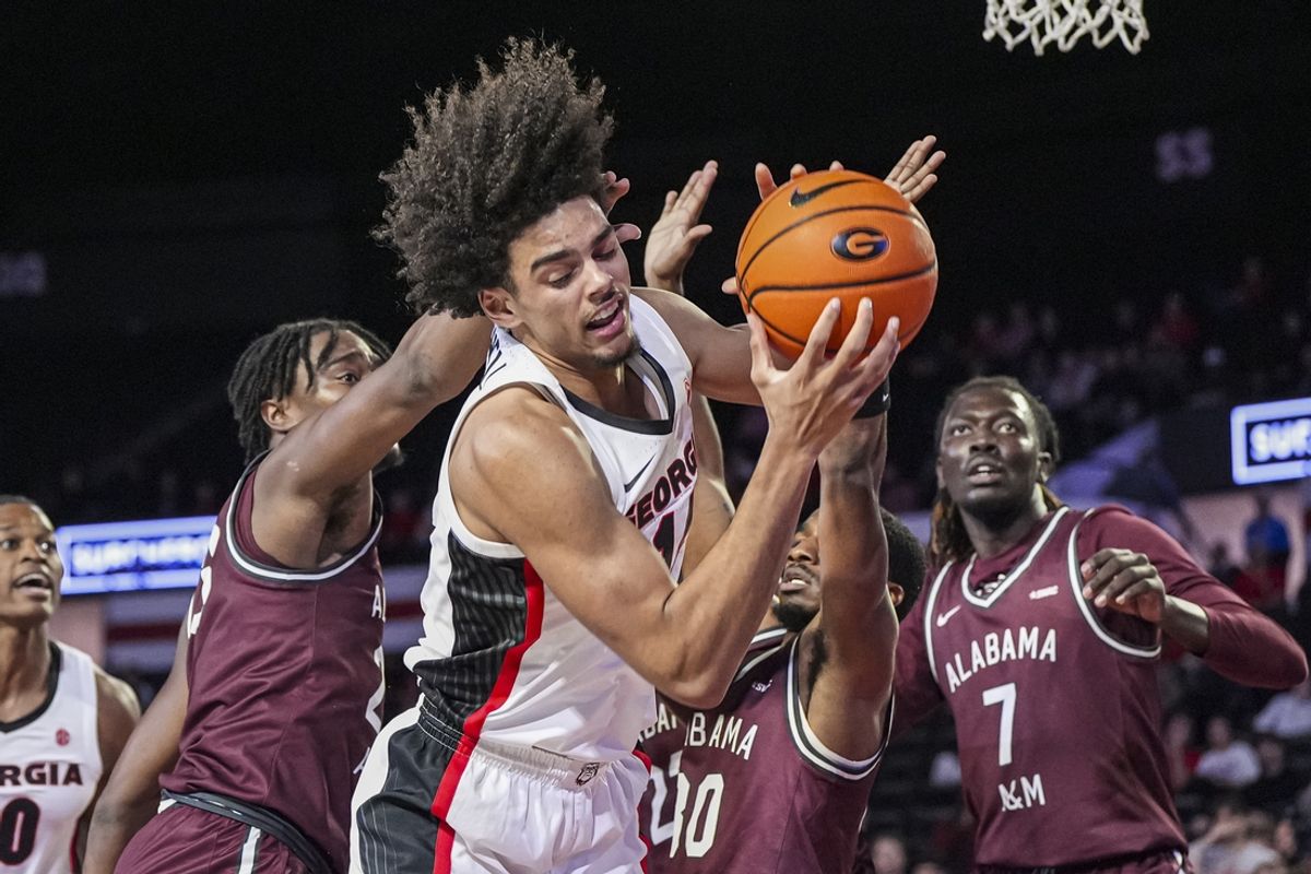 Nov 19, 2024; Athens, Georgia, USA; Georgia Bulldogs forward Asa Newell (14) grabs a rebound between Alabama A&M Bulldogs forward Chad Moodie (23) and guard Darius Ford (30) during the first half at Stegeman Coliseum. Mandatory Credit: Dale Zanine-Imagn Images