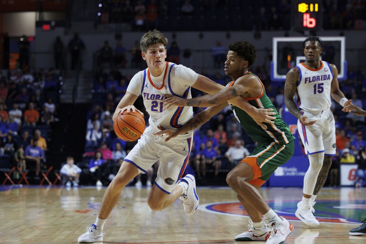 Nov 19, 2024; Gainesville, Florida, USA; Florida A&M Rattlers forward Shaqir O'Neal (8) defends Florida Gators forward Alex Condon (21) during the second half at Exactech Arena at the Stephen C. O'Connell Center. Mandatory Credit: Morgan Tencza-Imagn Images